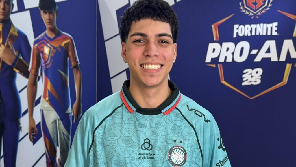 Smiling Fortnite esports player wearing a team jersey, standing in front of a Fortnite Pro-Am 2025 backdrop