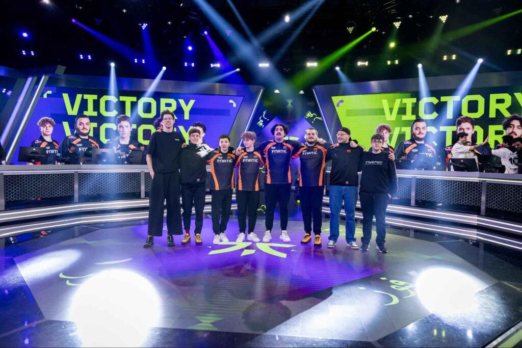NRG VALORANT roster standing on stage in orange jerseys during a VCT Americas event, featuring Ethan Arnold, Adam “mada” Pampuch, Brock “brawk” Somerhalder, Logan “skuba” Jenkins, and Georgio “keiko” Sanassy.