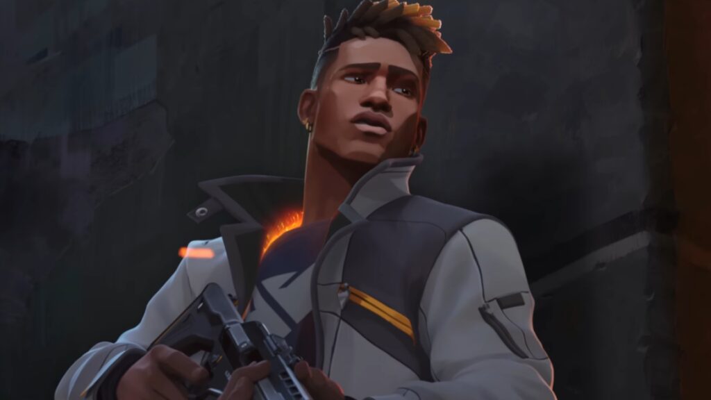 Phoenix stands in a dim alley holding a pistol, a fiery glow burning at his chest, symbolizing his fire-based abilities in VALORANT.